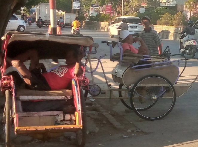 Dua orang penarik becak di Pemalang sedang menunggu penumpang