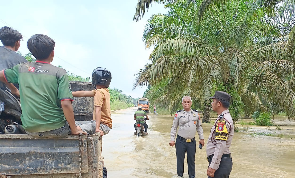 Suasana Jalan Lintas Simangambat ke arah Simpang Brakas yang tergenang air akibat Sungai Barumun meluap